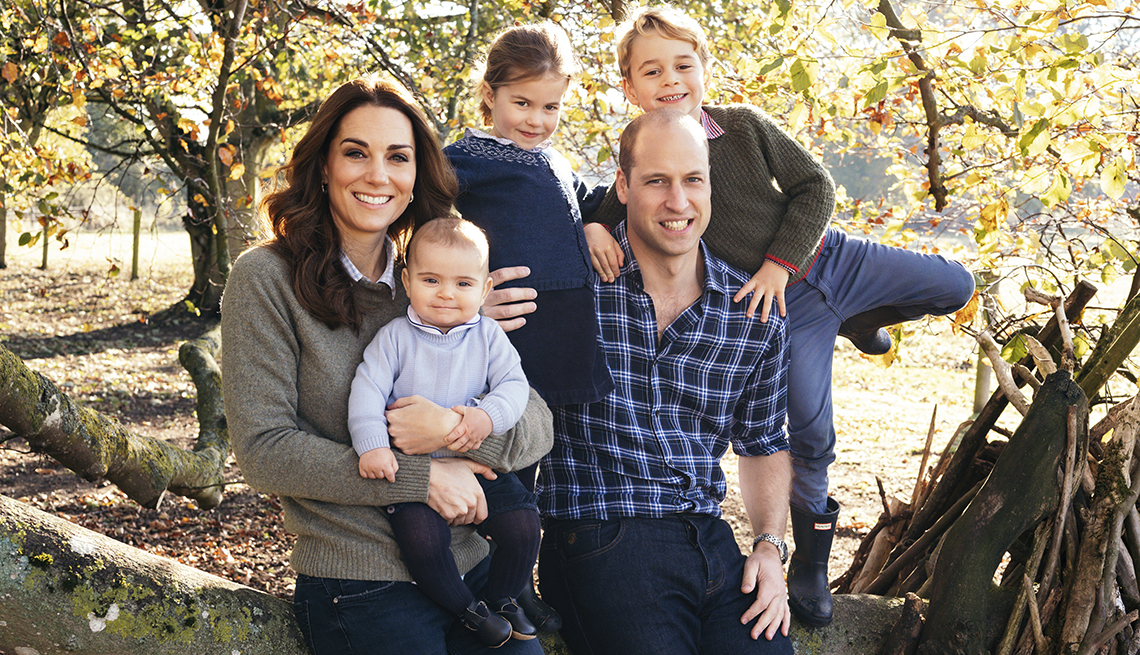 item 1 of Gallery image - The Duke and Duchess of Cambridge with their arms around their three children.