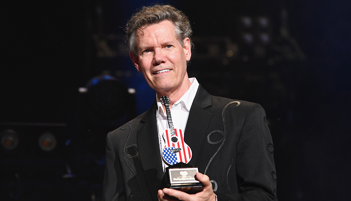 item 4 of Gallery image - Randy Travis holding an award