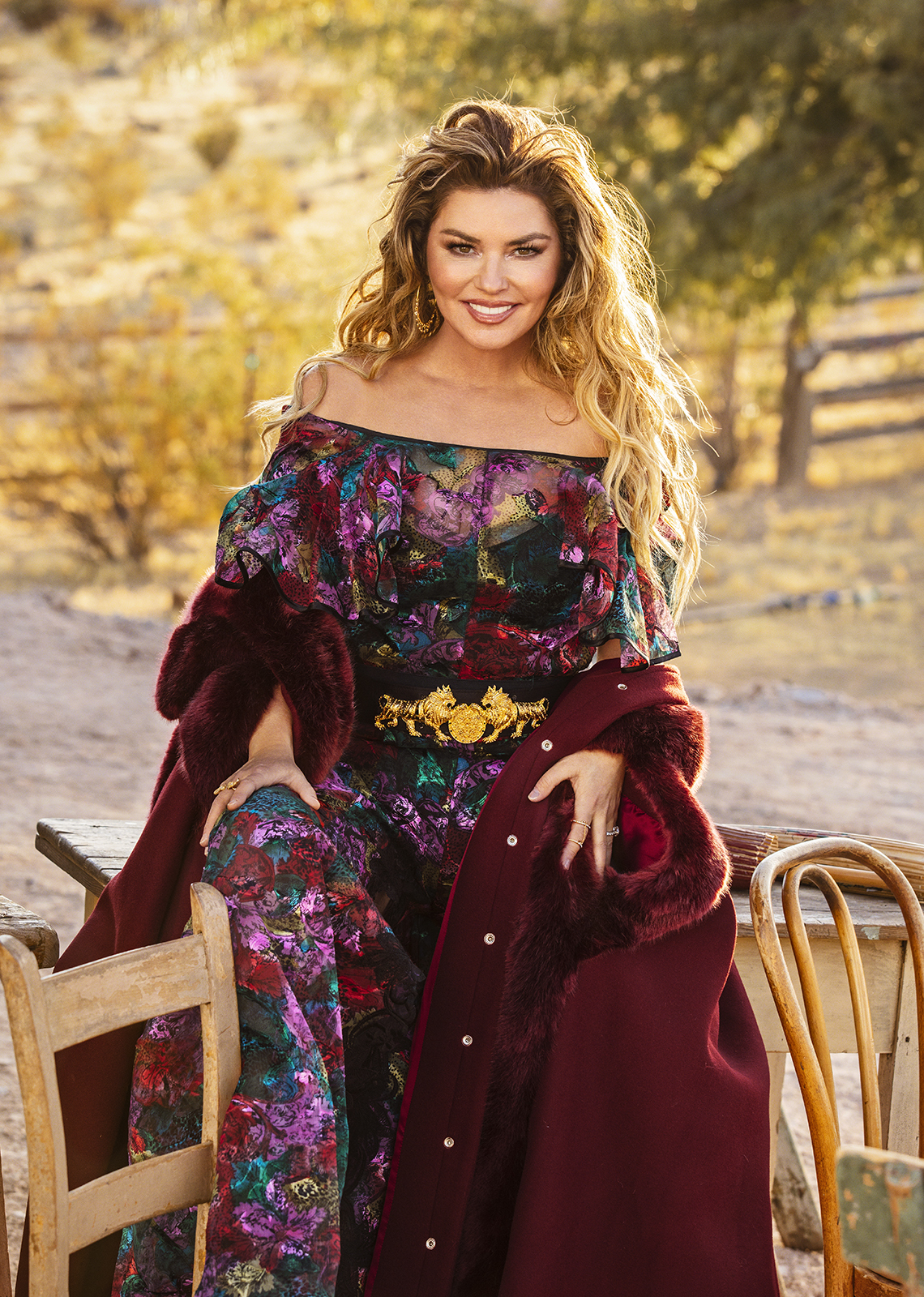 Shania Twain wearing a colorful dress outside on a horse farm