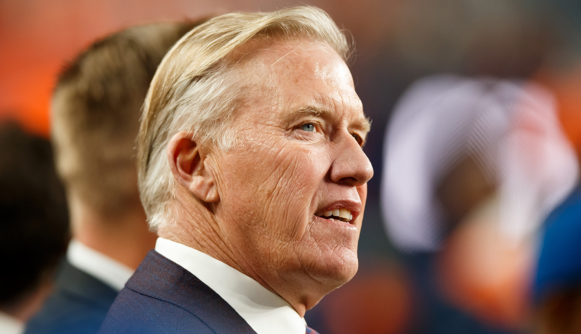 item 10 of Gallery image - Denver Broncos General manager and President of Football Operations John Elway standing on the sideline