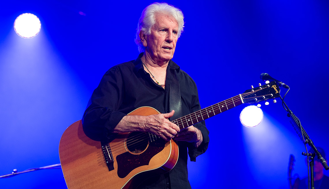 item 1 of Gallery image - Graham Nash with his acoustic guitar on stage at the Cambridge Folk Festival in England