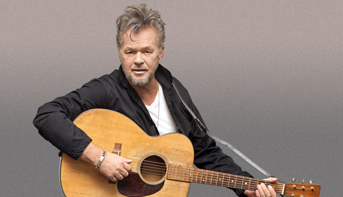 singer song writer john mellencamp poses with an acoustic guitar