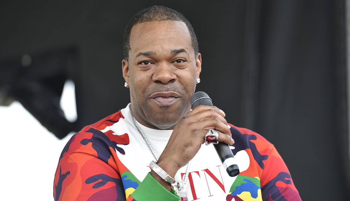 item 6 of Gallery image - Busta Rhymes holds a microphone while being interviewed on the PNC Stage at Union Home Mortgage Plaza at the Rock and Roll Hall of Fame and Museum in Cleveland Ohio