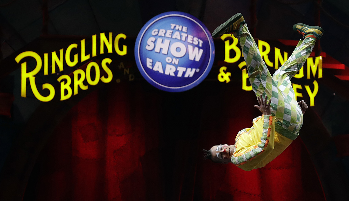 A Ringling Brothers and Barnum and Bailey clown performing a somersault during a performance