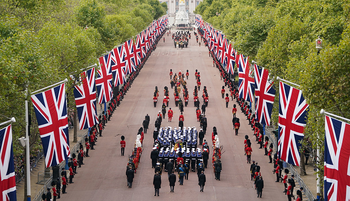 The State Gun Carriage carries the coffin of Queen Elizabeth II, draped in the Royal Standard with the Imperial State Crown and the Sovereign's orb and sceptre, in the Ceremonial Procession following her State Funeral at Westminster Abbey