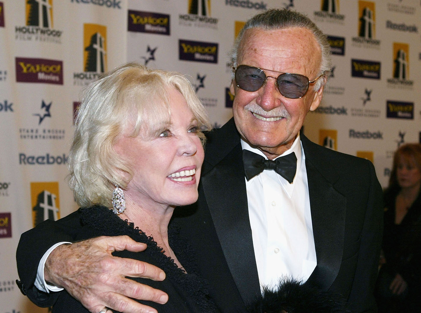 stan lee with his arm around wife