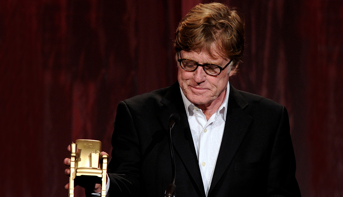 item 9 of Gallery image - Robert Redford looks down at his Movies for Grownups Award