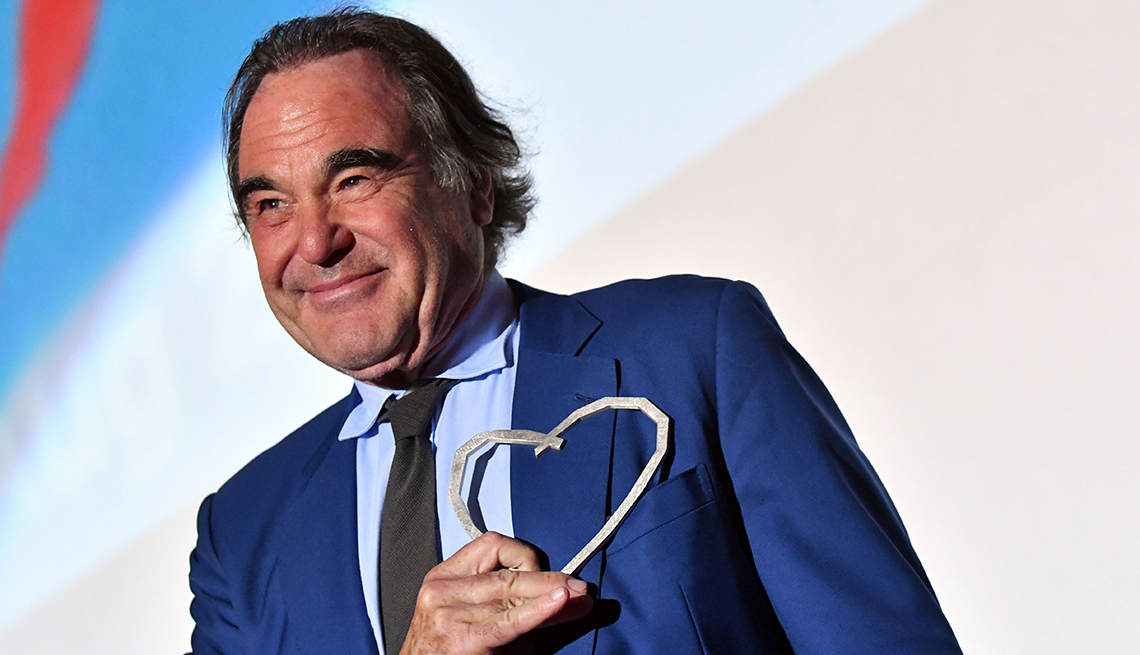 Oliver Stone poses for a picture with a Heart Of Sarajevo award