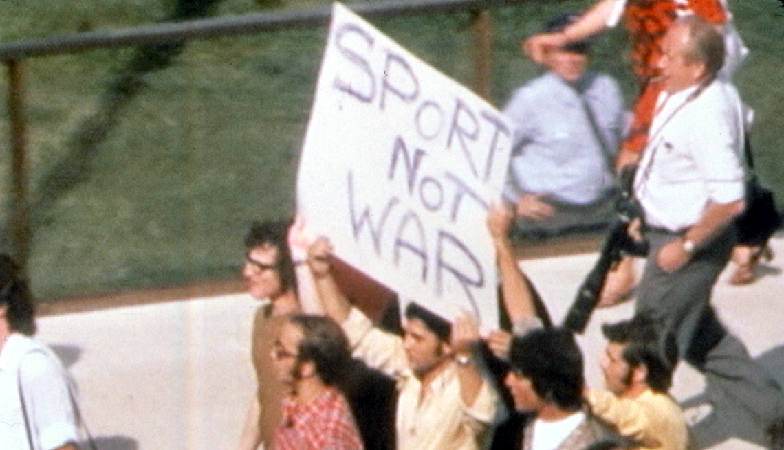 A protester holds a Sport Not War sign in the 1999 documentary One Day in September