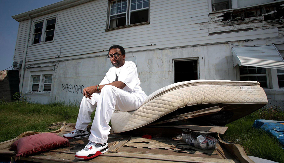 Spike Lee sitting on a mattress and other debris for a photo for the H B O documentary When the Levees Broke A Requiem in Four Acts