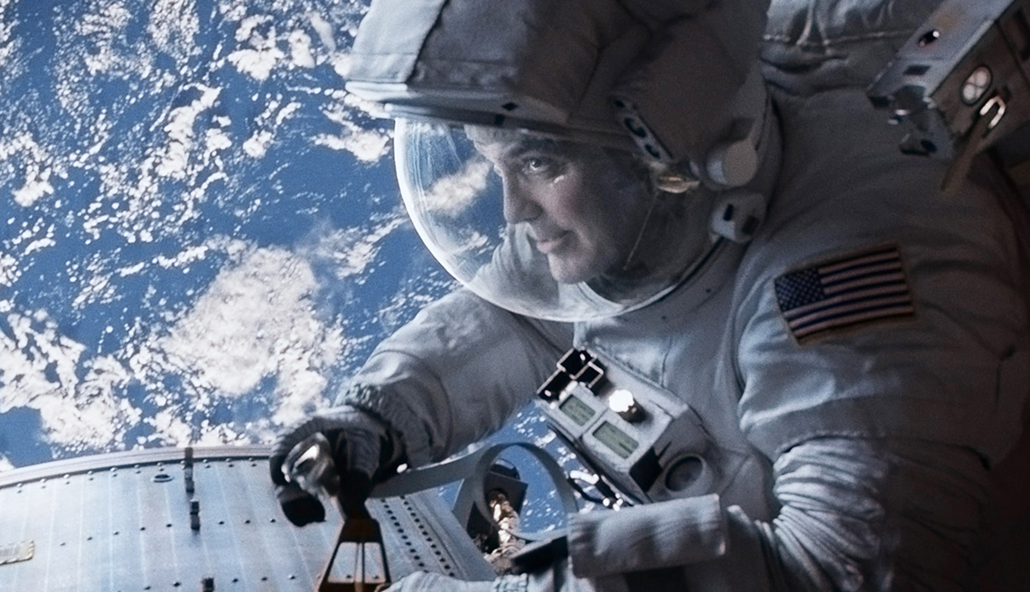 item 4 of Gallery image - George Clooney wearing a spacesuit in space in the film Gravity
