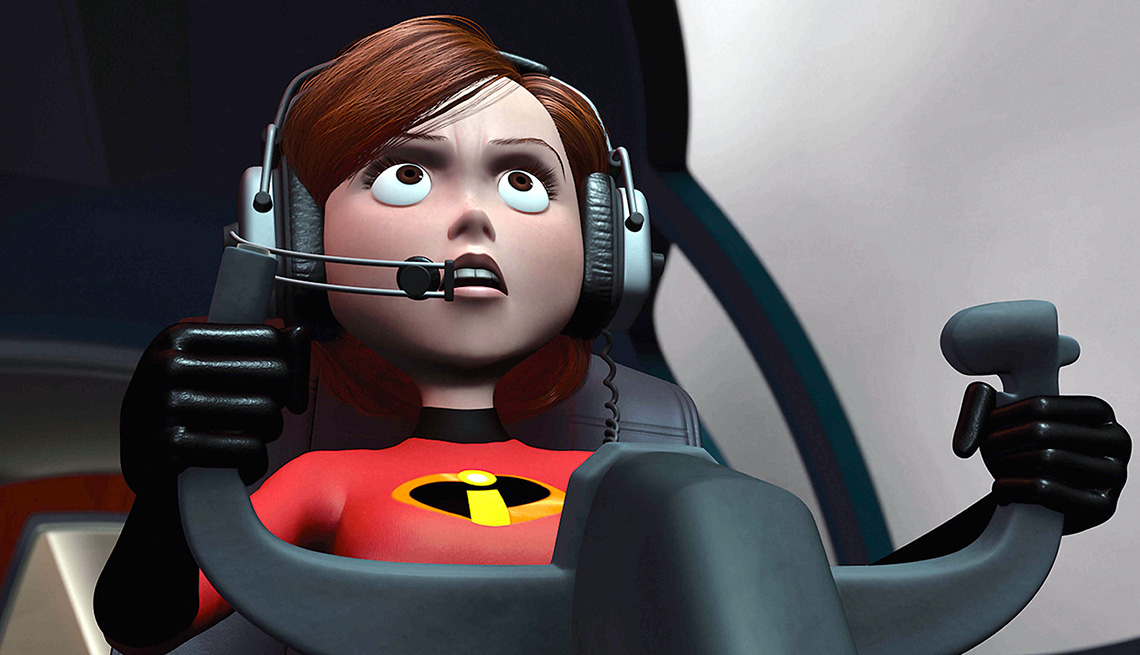 Elastigirl sitting behind a steering wheel and wearing a headset in the animated film The Incredibles