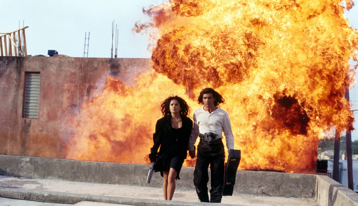 item 3 of Gallery image - Salma Hayek and Antonio Banderas walk away from a fiery explosion in the film Desperado