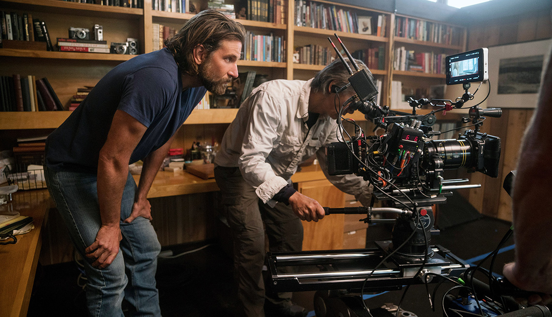 Director Bradley Cooper looking on behind the camera on the set of A Star Is Born
