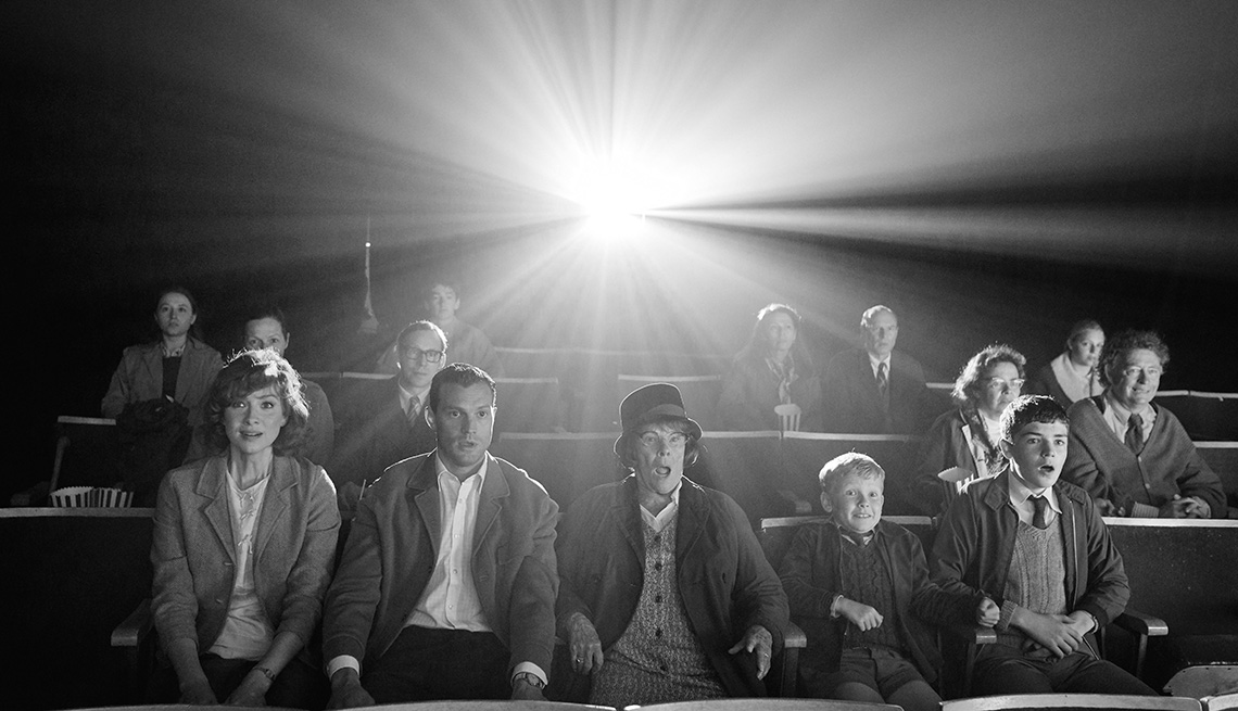 Theater goers watching a film in a scene from the movie Belfast