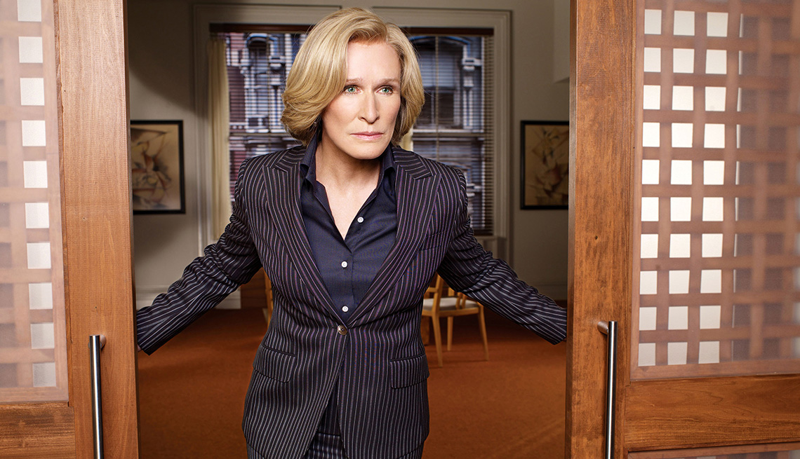 Glenn Close stand at the opening of a pair of sliding doors in the TV series Damages
