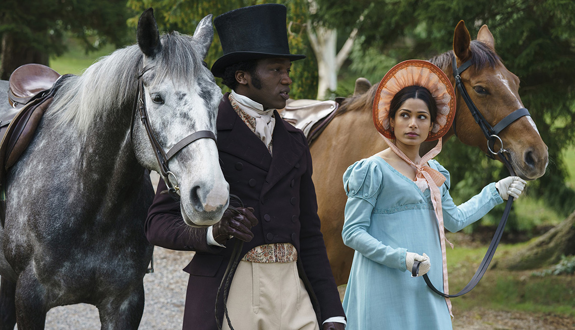 Sope Dirisu and Freida Pinto walk with their horses in the film Mr. Malcolm's List