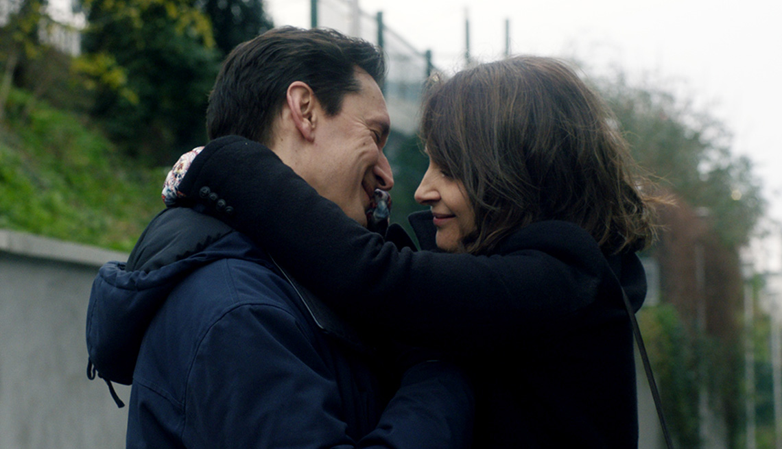 Gregoire Colin and Juliette Binoche hug in Both Sides of the Blade