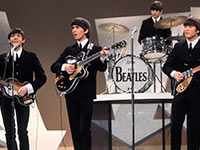 The Beatles perform for the first time on the Ed Sullivan TV show. 