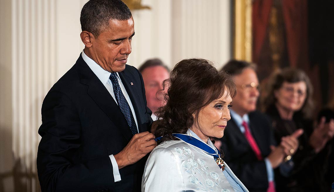 President Barack Obama presents the Presidential Medal of Freedom to country singer Loretta Lynn.