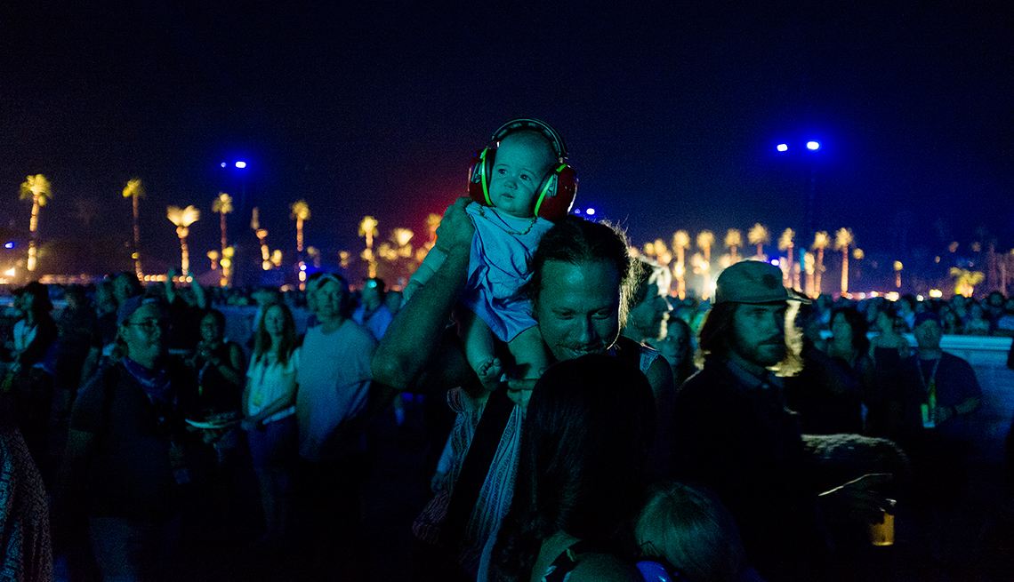 A very young concert attendee takes in the performance of The Who 