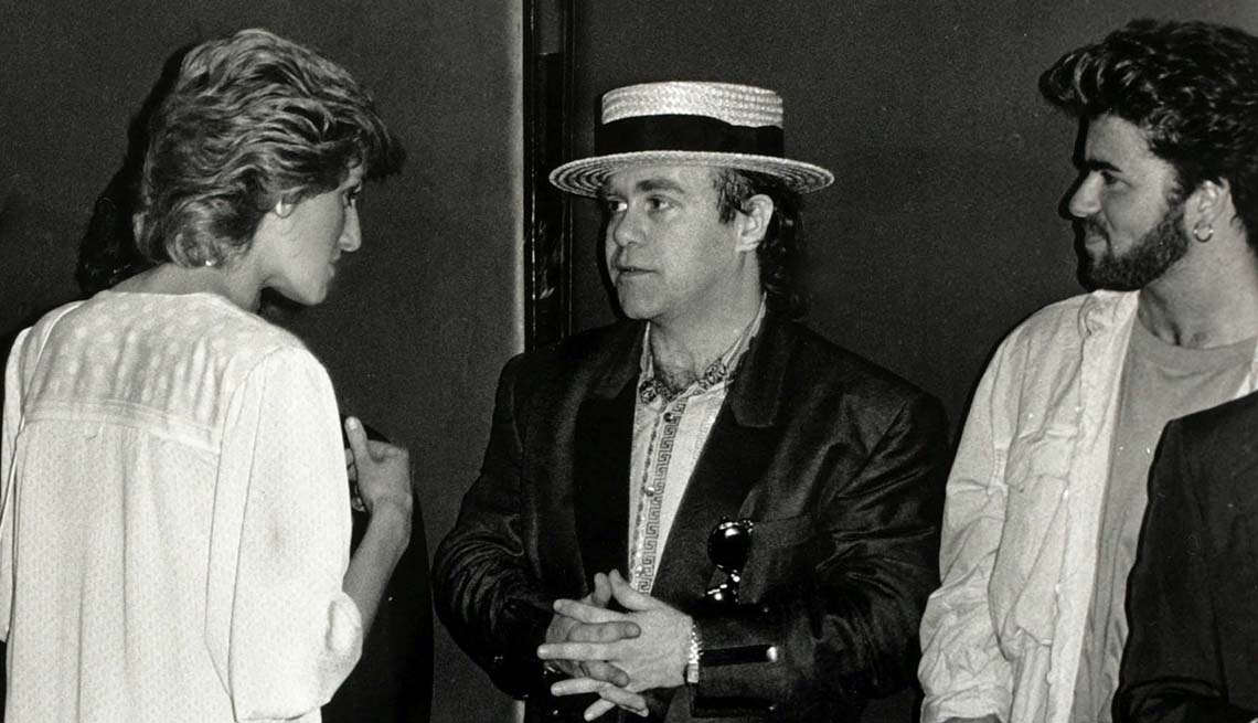 item 4 of Gallery image - Diana, Princess of Wales pictured chatting to musicians Elton John (centre) and George Michael at the "Feed the World" Live Aid concert at Wembley, July 1985.