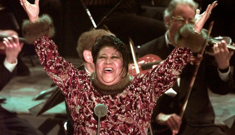 Aretha Franklin raises her arms in the air after performing Nessun Dorma at the 40th Annual Grammy Awards in New York