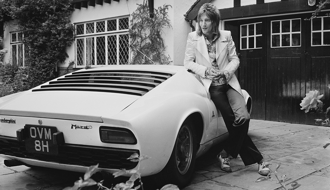 Rod Stewart standing next to his Lamborghini Miura