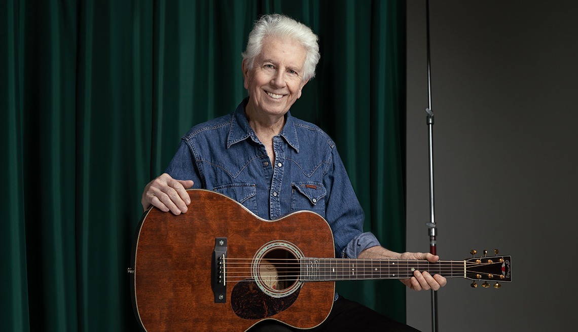Musician Graham Nash poses with his guitar