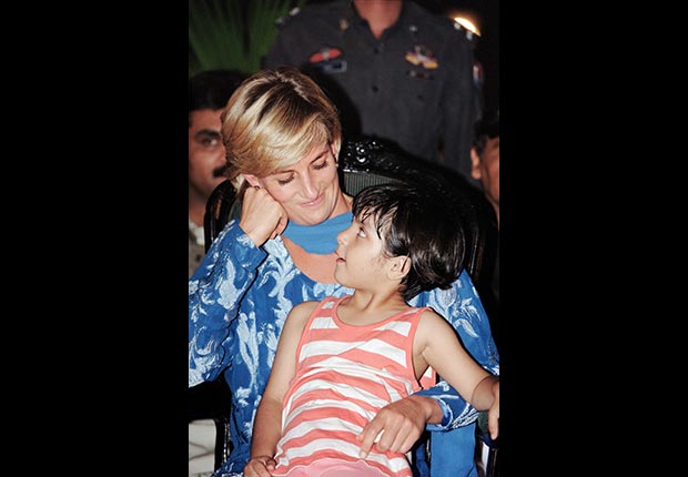 Princess Diana holds a young patient during a 1997 visit to Lahore, Pakistan. (Alamy)