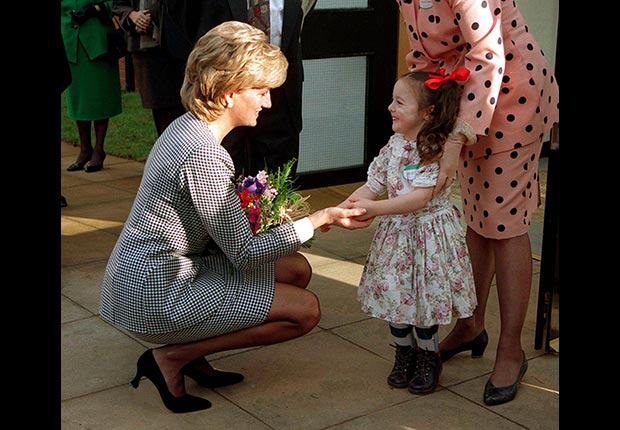 Princess Diana holding hands with a young girl in 1995. (Jayne Fincher/Getty Images)