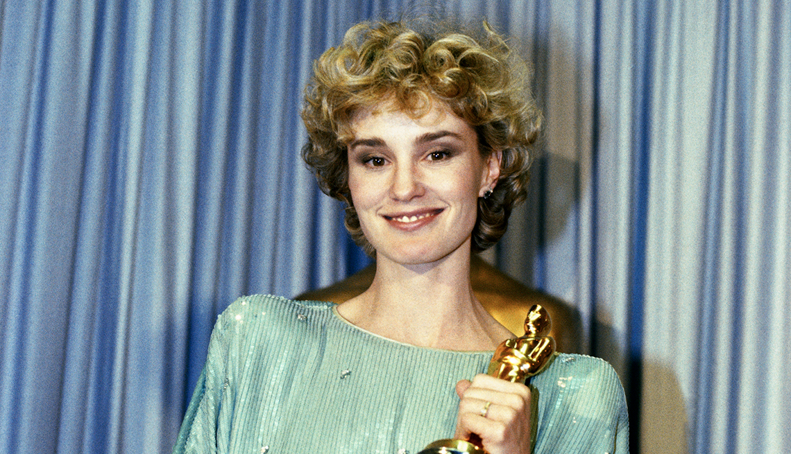 Jessica Lange holding the Oscar that she won for Best Actress in a Supporting Role, for her role in Tootsie
