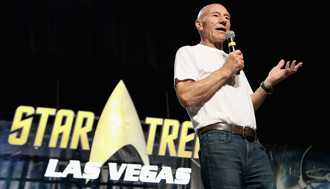 Patrick Stewart standing on stage with a sign behind him that reads "Star Trek Las Vegas.: