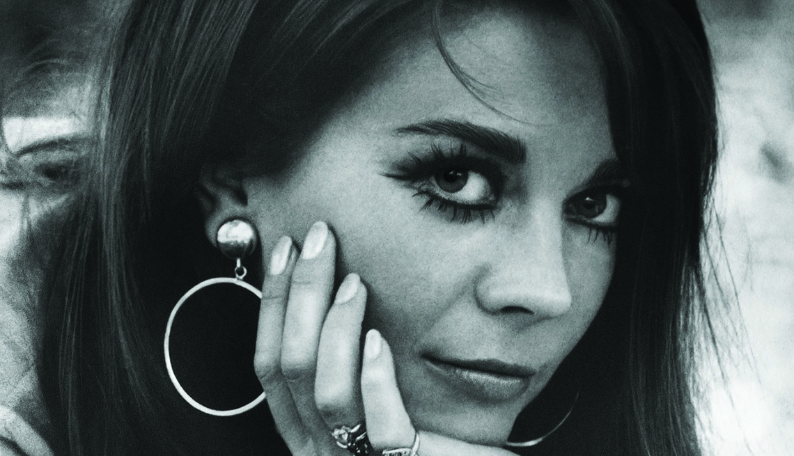Natalie Wood posing for photo where she places her hand under her chin to hold up her face