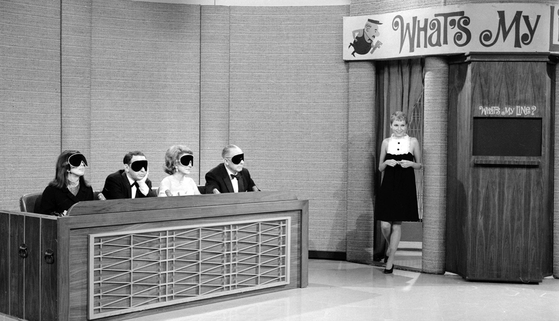 Panelists Phyllis Newman, Frank Sinatra, Arlene Francis and Bennett Cerf are blindfolded as mystery guest Mia Farrow appears on the TV show What's My Line