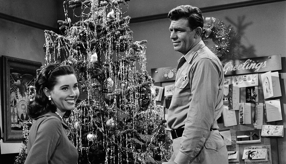 Elinor Donahue and Andy Griffith are nearby a Christmas tree in an episode titled Christmas Story on The Andy Griffith Show