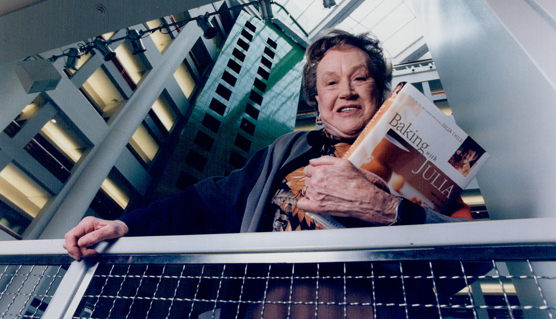 Julia Child holding her Baking With Julia book