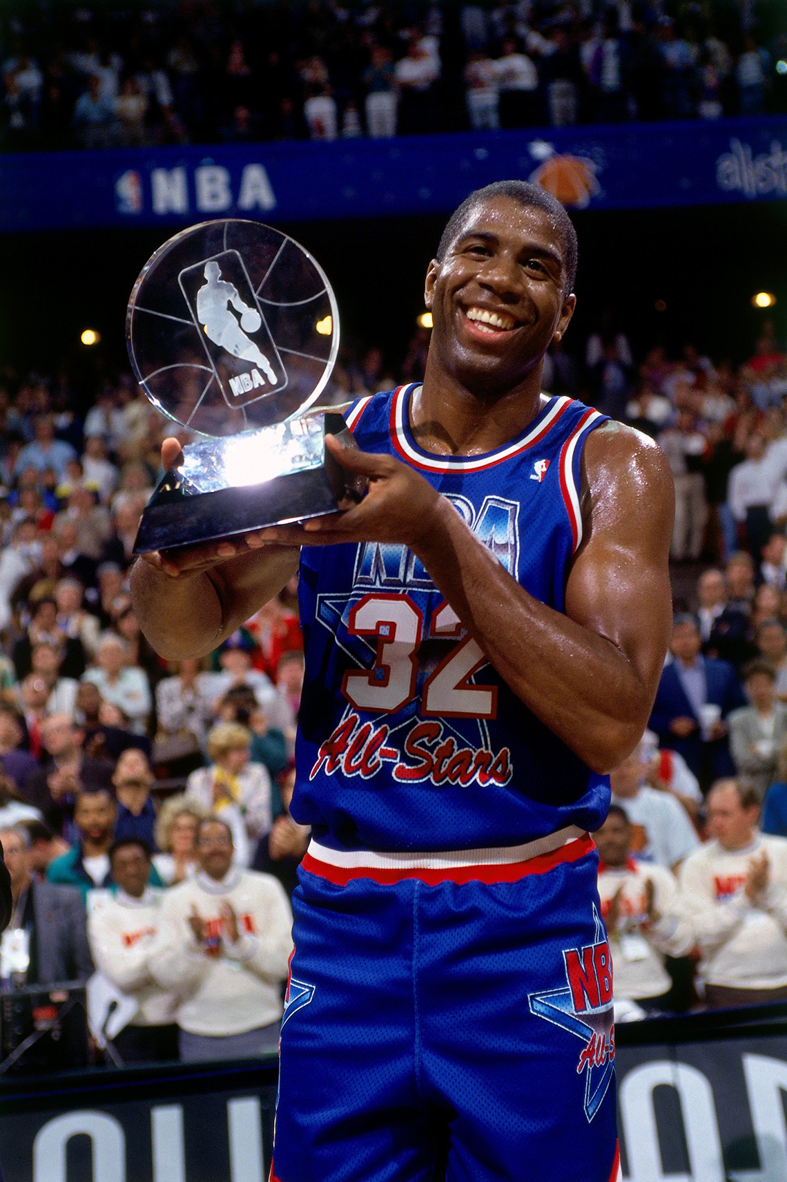 Magic Johnson holds his trophy after winning Most Valuable Player at the 1992 NBA All Star Game