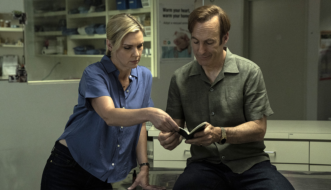 Rhea Seehorn and Bob Odenkirk look at a small notebook in Better Call Saul