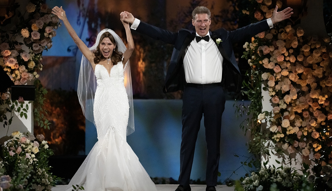 Theresa Nist and Gerry Turner raise their arms in the air after getting married during "The Golden Wedding."