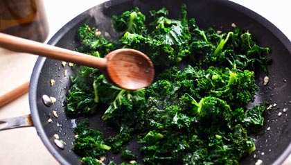 Sauteeing kale in skillet, current food trends