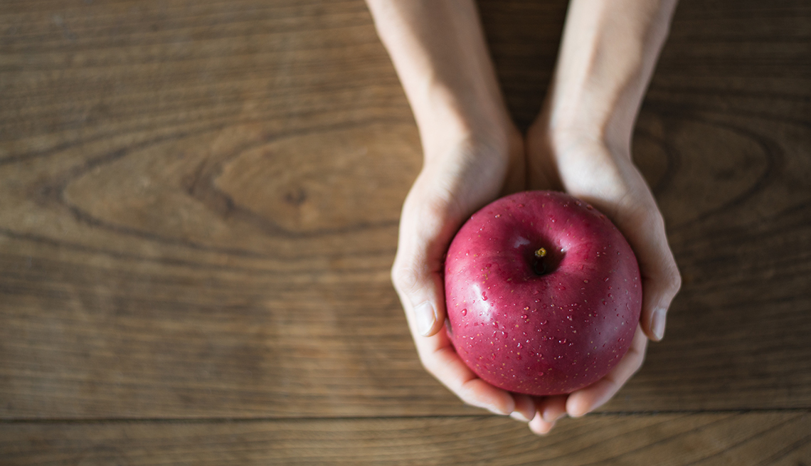A woman holding an apple