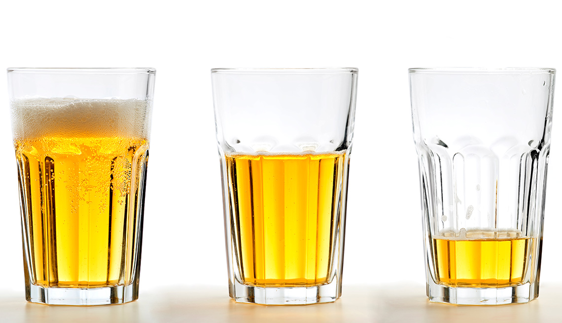 three beer glasses with liquid going down