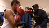 Junious Hinton spars with young boy