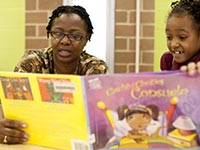 A woman reads to young girl, AARP Experience Corps Awards