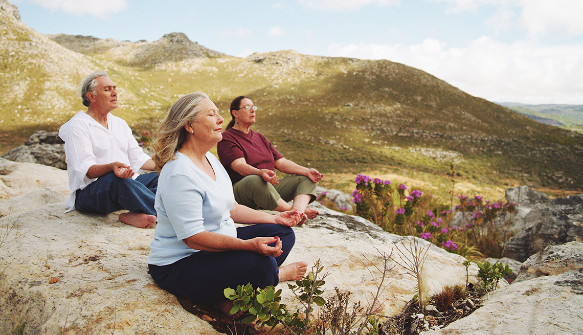People meditating on hillside