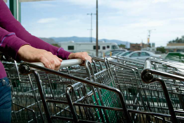 Woman selecting a shopping cart