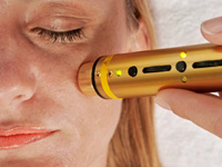 Woman patient receiving laser therapy procedure.