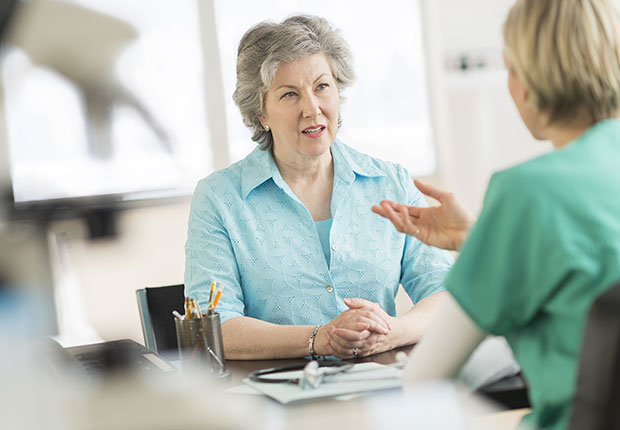 Doctor talking priorities to patient in office, How to Get the Right Hearing Aid: 10 Tips