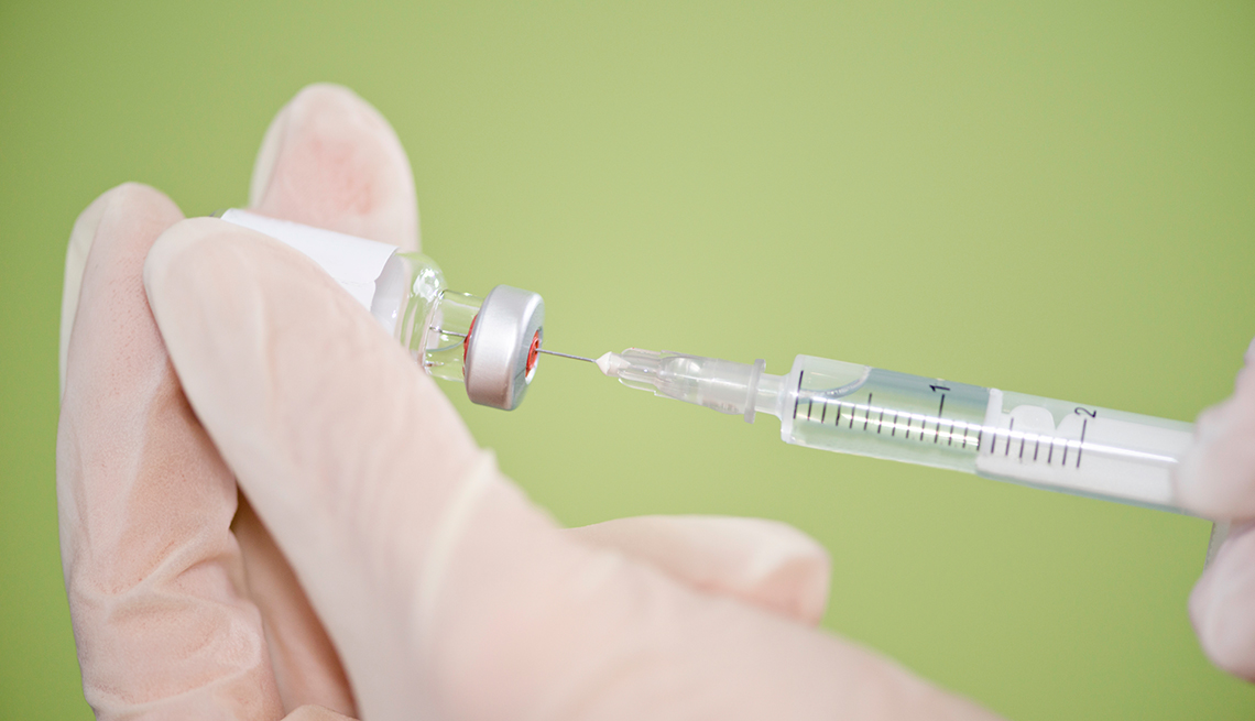 Vial and syringe in doctor's hands